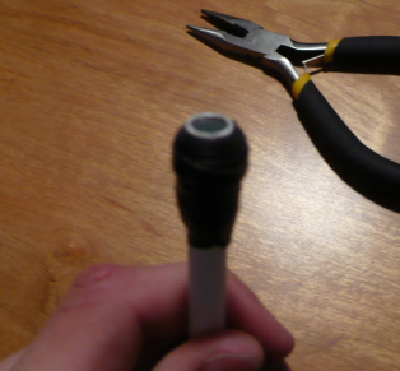 Wrap electrical tape around the paper clip to secure it, seal the holes, and create a &amp;quot;back-stop&amp;quot; for where the barrel/chamber meet (explained in next step).