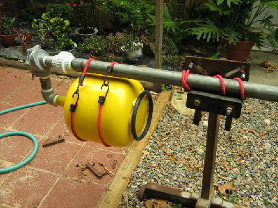 Close up of the stand. The tank literally hangs from the barrel by the straps.