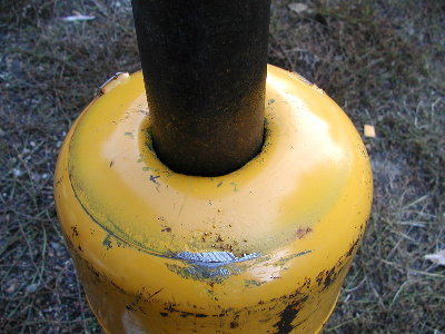 Detail showing the area to be welded.  I cut the holes smaller and beat them in to create a space for the weld.  The bevel reduces the possibility of an explosive weld failure causing a tank rupture.