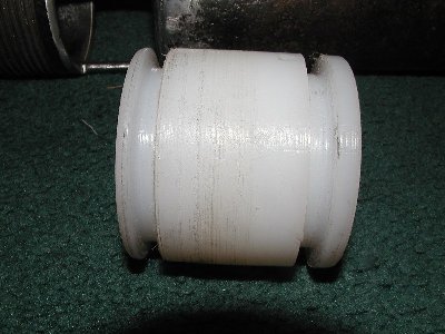 Side view of the piston showing the short rounded nose of the piston.