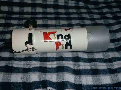 Side view of KingPin and all her accessories. From top to bottom you can see the pressure gauge, Schrader valve, battery, and contacts. I made the contacts myself, two pieces of metal that were normally closed until a thin piece of plastic was slid between them. The plastic was tied to the trip wire so when the wire was tripped the plastic would pull out and complete the circuit.