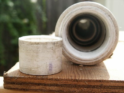 With the piston out you can see the valve seat.<br />The piston was gently sanded on a piece of sandpaper glued to the plywood until it just fit inside the breech.  Note the sanded appearance.