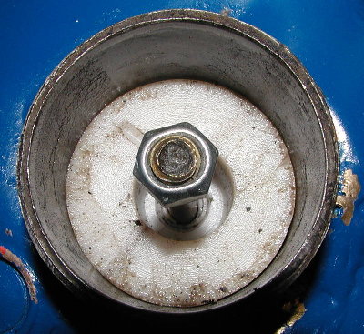 Remove the nut and pull out the piston to service the valve.