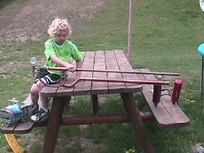 little brother holding up the gun for me on our day shooting at my house together