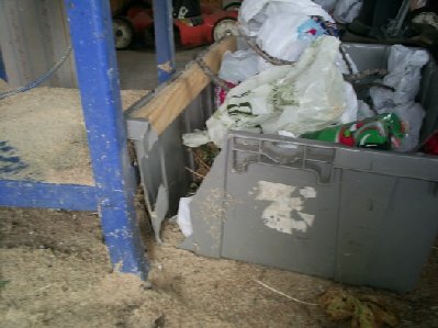 Garbage bin that was ripped open from dowel on its way through the shed.