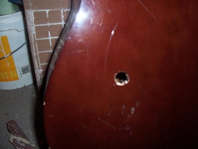 Close up of a perfect round hole.<br />This guitar was always out of tune ( poor quality) and had tosuffer the consequences..