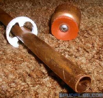 The seat end of the barrel, along with the spacer and front of the piston.