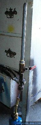 The gun is set over a propane torch to heat up and boil the water inside the chamber.